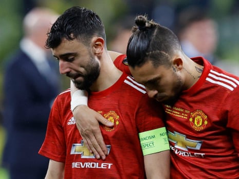 Manchester United’s Bruno Fernandes is consoled by Alex Telles.