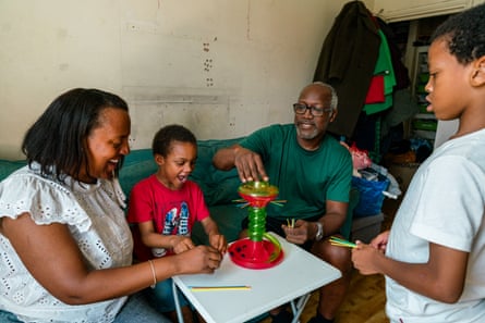 Two adults and two children playing a tabletop game
