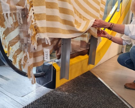 Deer stuck in escalator covered by blanket
