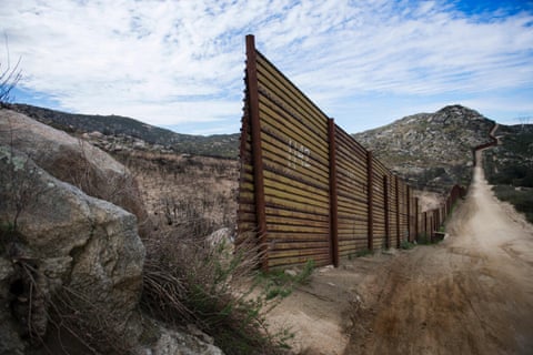 A section of the border fence ends and stands open on the US/Mexico border in Tecate, California