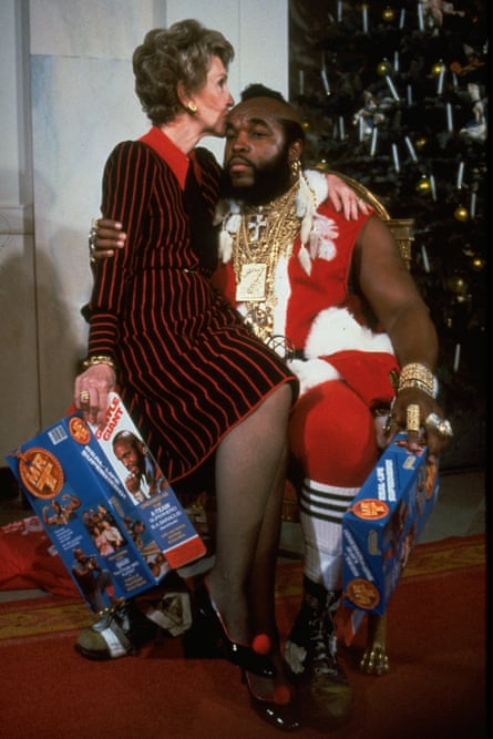Nancy sits on Mr T’s knee and kisses his forehead