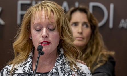 Survivor Kara Cagle, foreground, speaks as fellow survivor Julie Wallach reaches out to comfort her during a news conference.