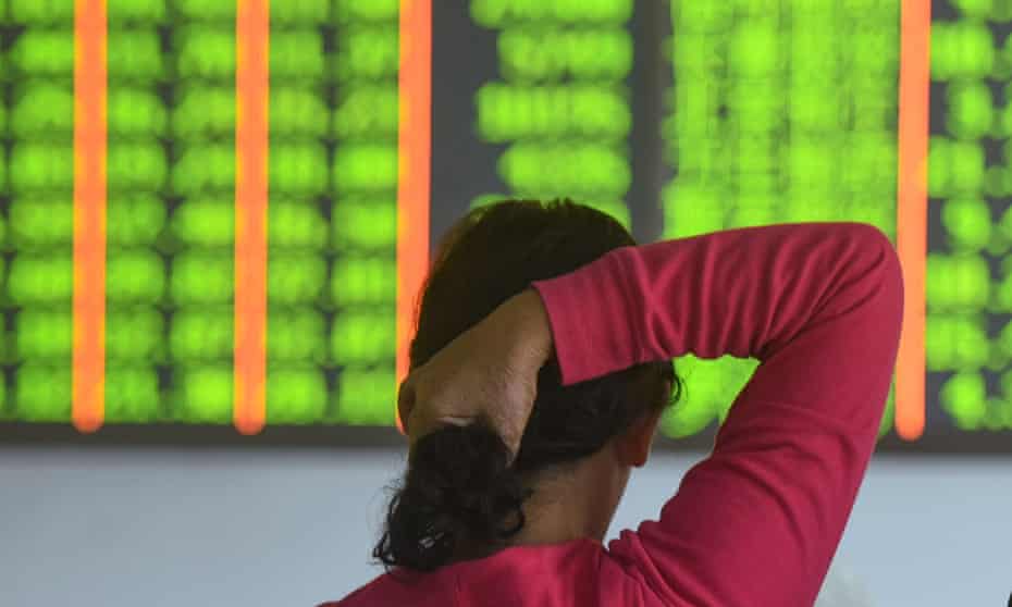 An investor monitors stock prices at a Chinese securities firm in Hangzhou.