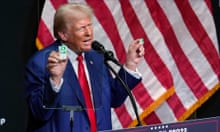 Donald Trump holding up boxes of Tic Tacs