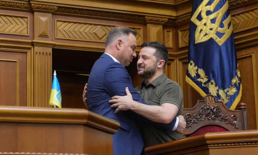 Polish President Andrzej Duda embraces Ukraine’s President Volodymyr Zelenskiy during a session of Ukrainian parliament, as Russia’s attack on Ukraine continues