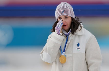 Julia Simon of France wipes away tears after she received her gold medal following victory in the women's 15km individual biathlon.
