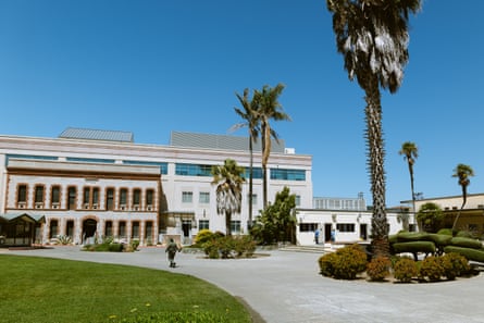 exterior of prison building with palm trees and a blue sky