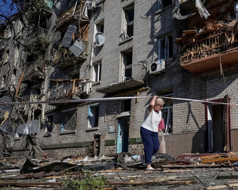 A resident walks near an apartment building damaged during a Russian missile and drone strike, amid Russia's attack on Ukraine, in Kyiv.