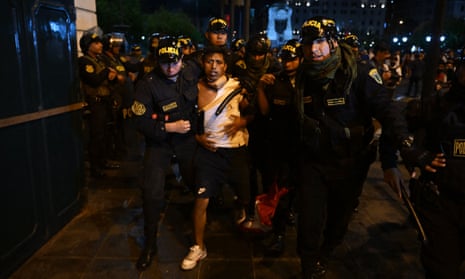 Police arrest a protester during a demonstration in Lima