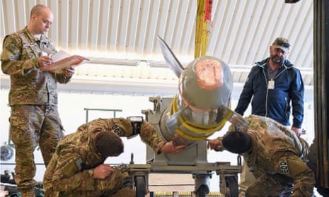 A photo in a Los Alamos National Laboratory student briefing from 2022 showing four people inspecting what appears to be a damaged B61 nuclear bomb.