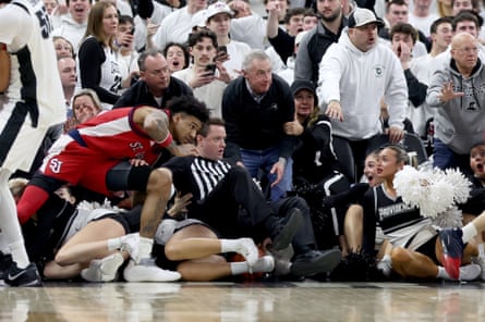 St John’s forward Dillon Mitchell and a game official fall after a fight broke out in Saturday’s game.
