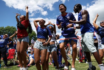Cape Verde fans Ginaldo Verdieu, Alex Monteiro and Bruna Barbosa react as they watch the match on a screen in Dorchester, Boston