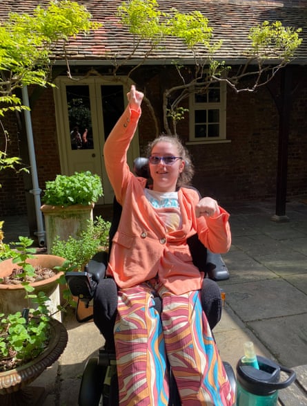 Katie in a garden in her wheelchair