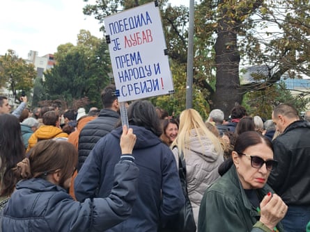 A Student List supporter with a placard saying ‘Love prevailed for the people and Serbia’