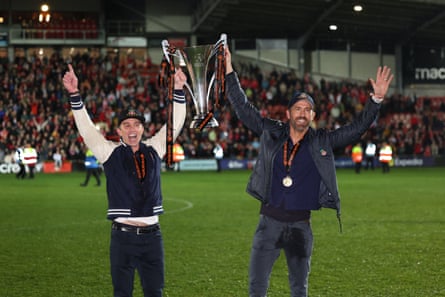 Rob McElhenney (left) and Ryan Reynolds celebrate promotion with the National League trophy