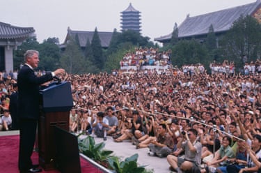 A crowd of students applaud Clinton who is on stage