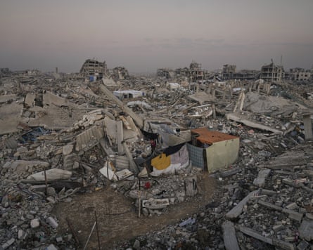 A makeshift tent set up amid the rubble and destruction that stretches into the distance