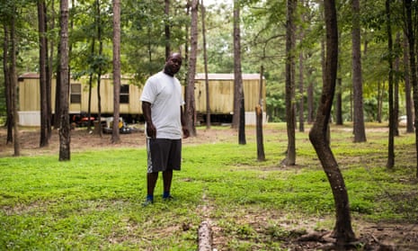 Aaron Thigpen, 29, observes a site where raw sewage is dumped through a PVC pipe only a few yards away from a home in Lowndes county, Alabama.