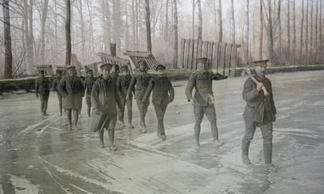 Members of the Royal Garrison Artillery carry duck-boards across the frozen Somme at Frise, France.