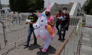 A woman dressed as a unicorn heads to the esplanade of the Municipal Palace of Nezahualcóyotl, State of Mexico, to receive the first dose of the Sinovac vaccine.
