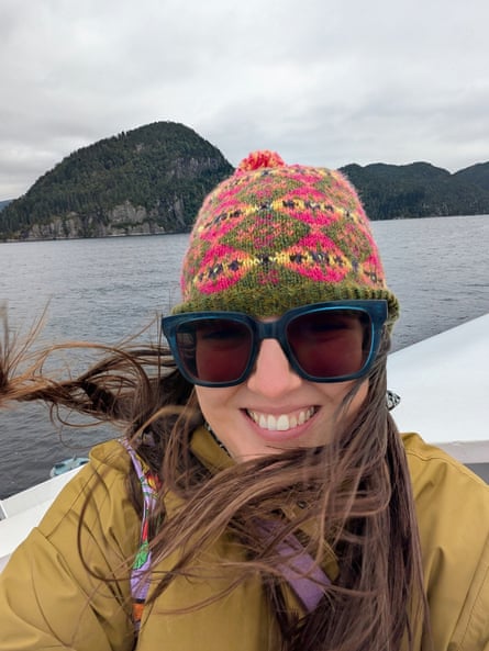Helen Barwick taking a boat trip while wearing a knitted hat, winter clothes and sunglasses.