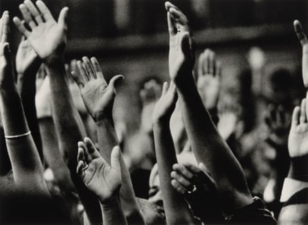 black and white photo of people raising hands