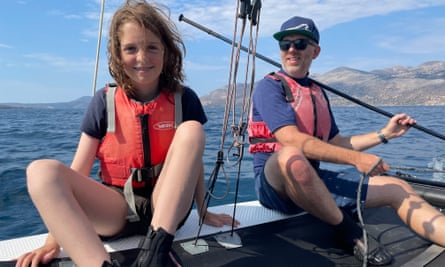 Wyl Menmuir and daughter on a catamaran