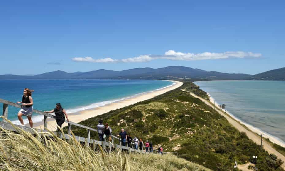 Tourists walk to a lookout at The Neck on Bruny Island in Tasmania.