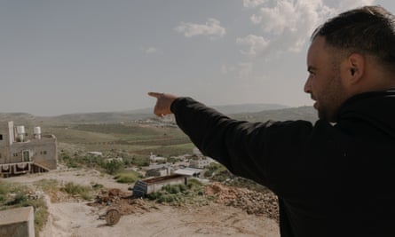 Mahmoud Haj Mohammed points to a settlement