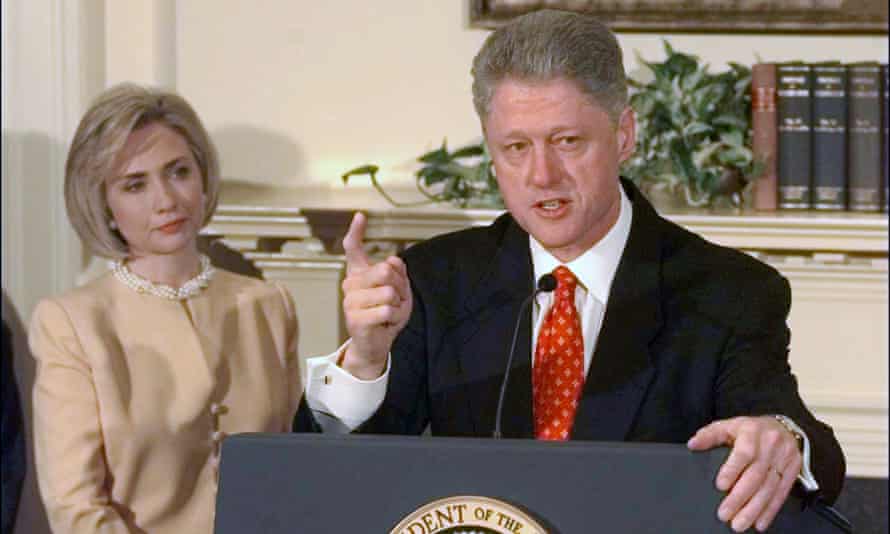 Bill Clinton speaks on the scandal as Hillary Clinton looks on.