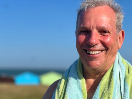 Nick smiles with a towel around his shoulders