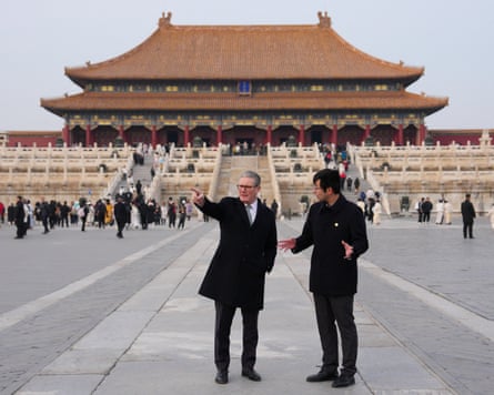 Keir Starmer pointing while talking to a person at the Forbidden City in China.