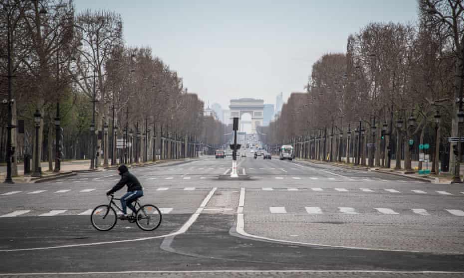 A cyclist rides in the empty streets of the French capital during lockdown measures.