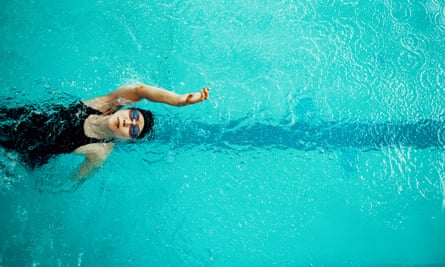 View from above a woman training in a pool for competitive swimming