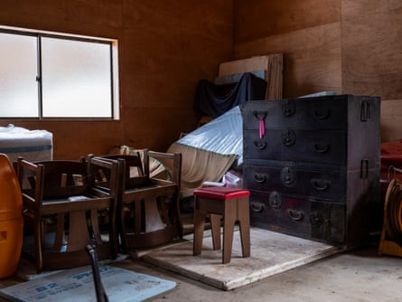 Items including chairs and a chest of drawers in a bare room