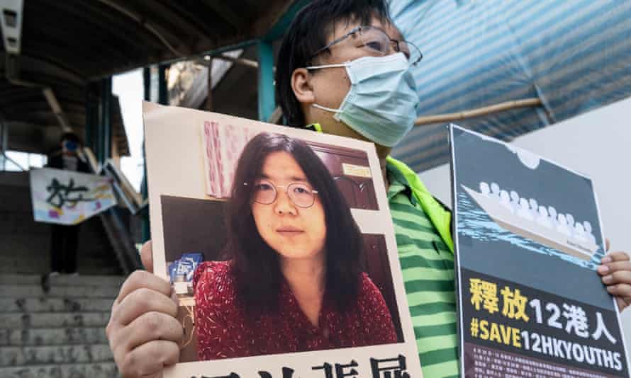 A pro-democracy activist holds up a signs in support of Chinese citizen journalist Zhang Zhan who has been sentence to four years in prison and the 12 arrested people in China in Hong Kong, China, 28 December 2020.