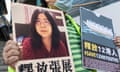 A pro-democracy activist in Hong Kong holds up signs in support of Zhang Zhan, a citizen journalist who has been in prison since 2020