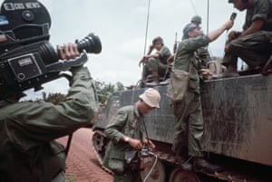 A CBS camera crew interviews American soldiers, Tay Ninh Road, Vietnam, 1967