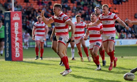 Leigh Centurions players in action against Widnes Vikings.