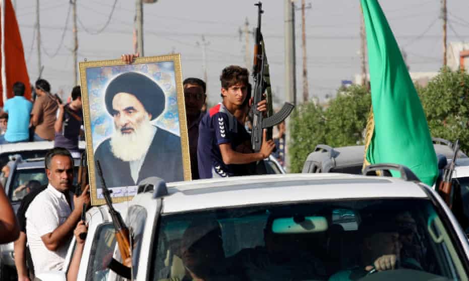 Iraqi army volunteers hold a picture of Ayatollah Ali Sistani in Sadr City, Baghdad