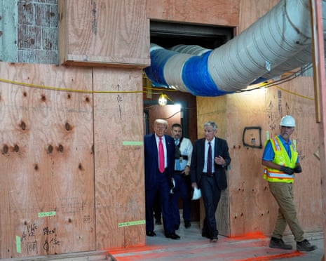 Men tour a building construction site.
