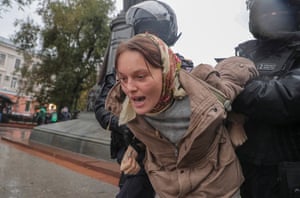 Policemen detain a person at an unauthorised protest in Russia against the country’s partial military mobilisation due to the conflict in Ukraine