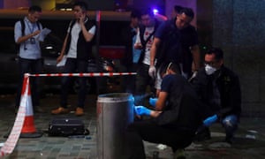 Police collect evidence at the scene of the attack in the Taikoo Shing district of Hong Kong.