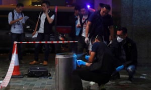 Police collect evidence at the scene of the attack in the Taikoo Shing district of Hong Kong.