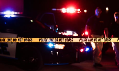 Police vehicle with flashing lights and police tape.