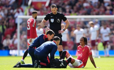 Leny Yoro receives treatment after going down injured during Manchester United’s game against West Ham.