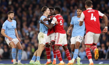 Jack Grealish of Manchester City clashes with Thomas Partey of Arsenal