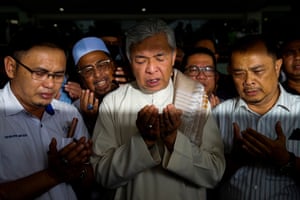 Shah Alam, Malaysia: former deputy prime minister Ahmad Zahid Hamidi (C) prays with his supporters while leaving the high court