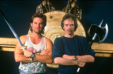 One man successful a achromatic singlet holding a sword. One man successful a achromatic jumper, pinch a moustache, holding an axe