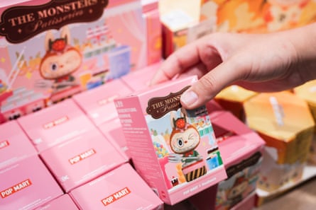 A visitor browses through collectible toys inside a Pop Mart store